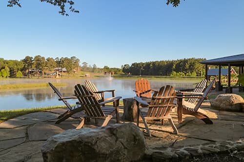 adirondack chairs next to a lake