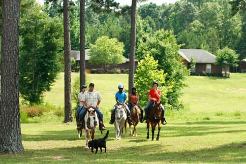 Lady leads a group of riders at oxford treatment center