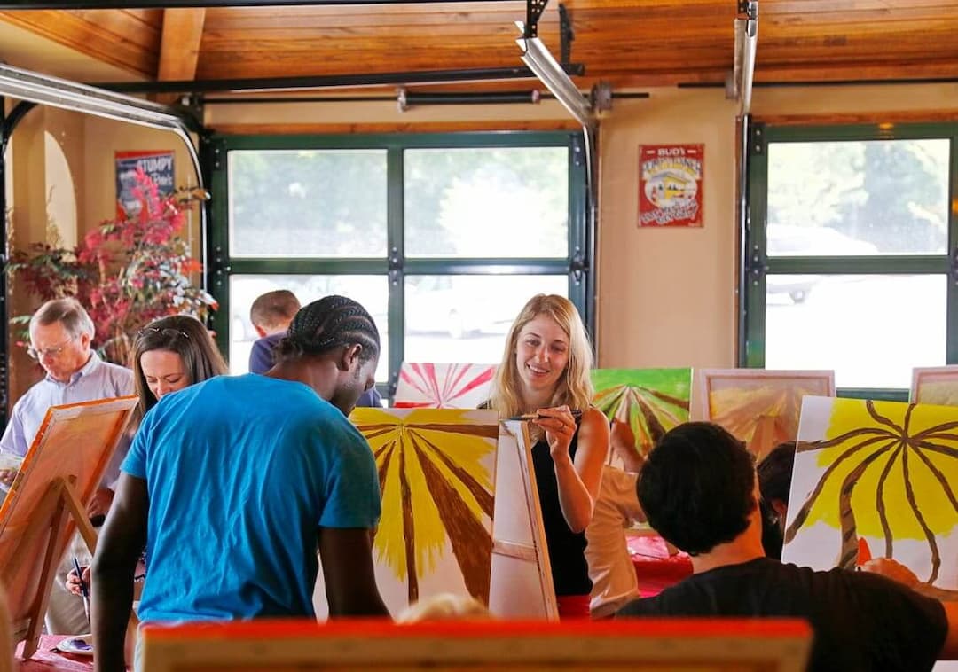 group of people painting on canvas for therapy