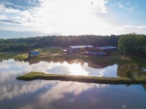 Beautiful aerial photo of Oxford Treatment Center's campus, with sunny blue skies and a shimmering lake.