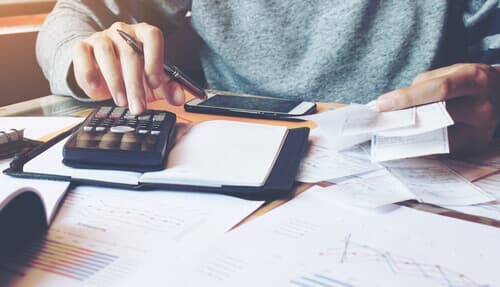 man calculating bills at home office