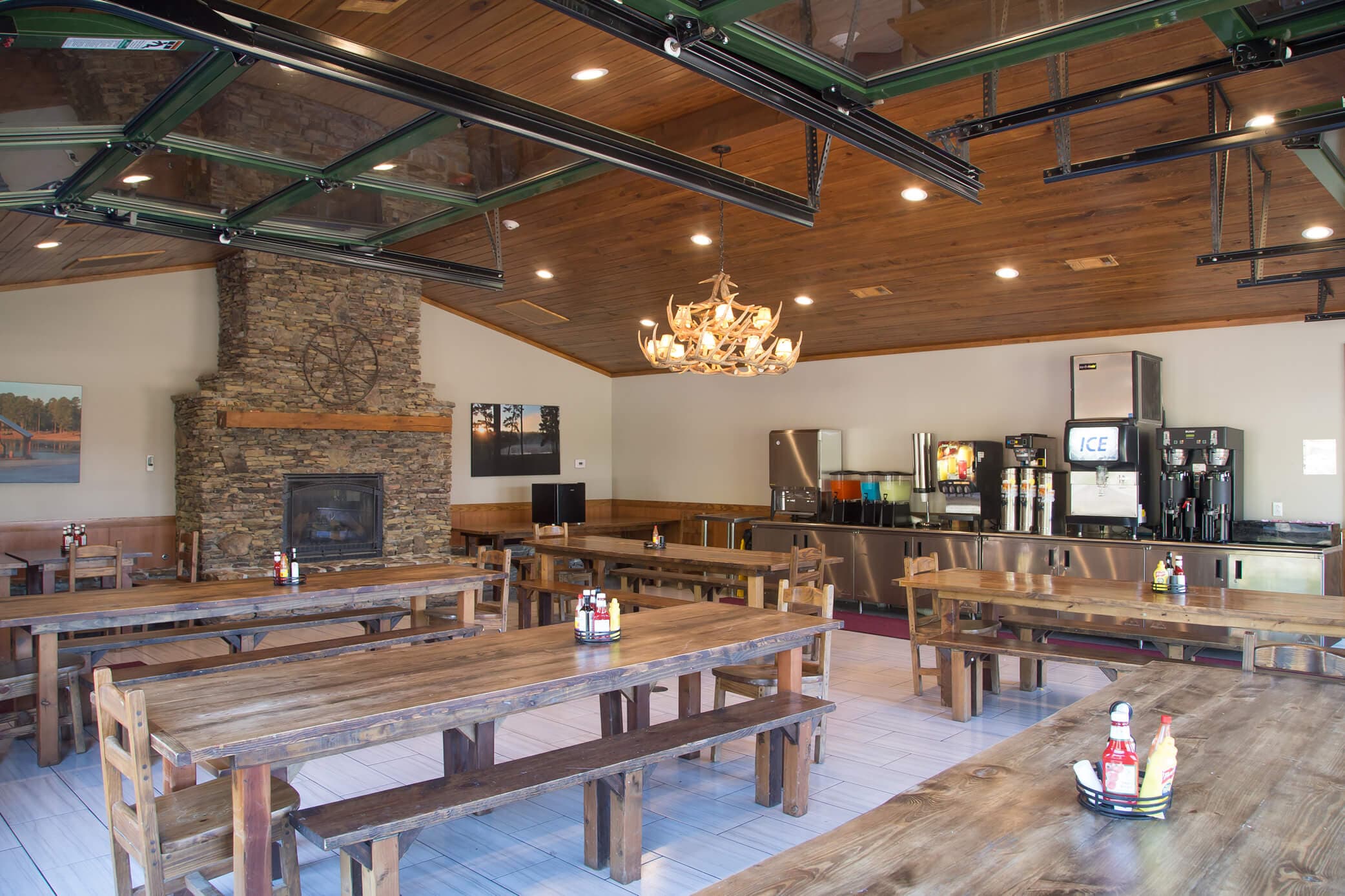 Dining hall with chandelier and wood tables with benches