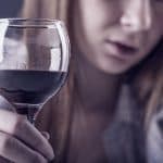 woman suffering from negative side effects after mixing oxycotin and alcohol