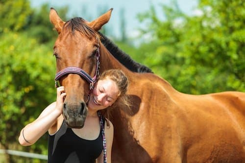 female patient taking part in equine assisted therapy