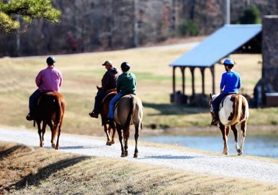 Four people riding horses at treatment facility in Mississippi